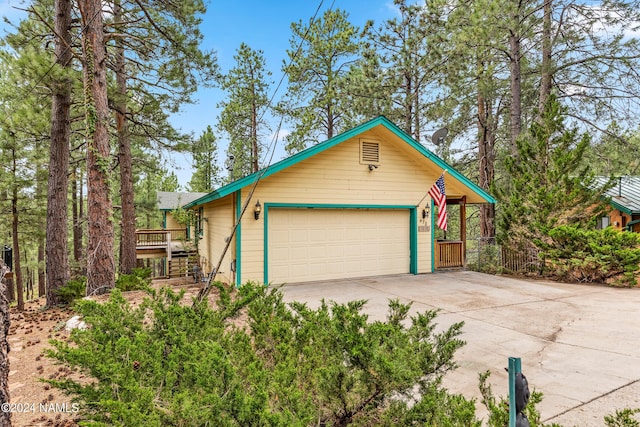 view of front of home featuring a deck and a garage