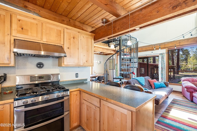 428 Cherokee, Flagstaff, AZ 86005 - kitchen featuring double oven range, under cabinet range hood, wood ceiling with exposed beams, light brown cabinets, and open floor plan