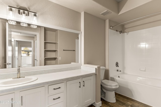 full bathroom featuring bathtub / shower combination, vanity, toilet, and wood-type flooring