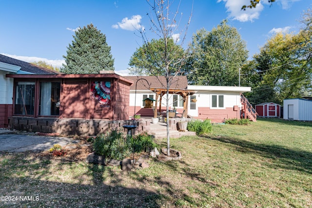 view of front of house with a patio, a hot tub, a front yard, and a shed