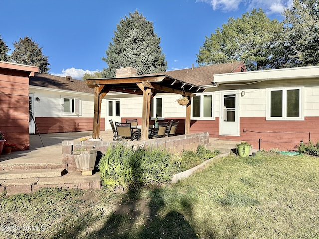 back of house featuring a patio area and a lawn