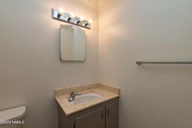 bathroom with crown molding, toilet, and vanity