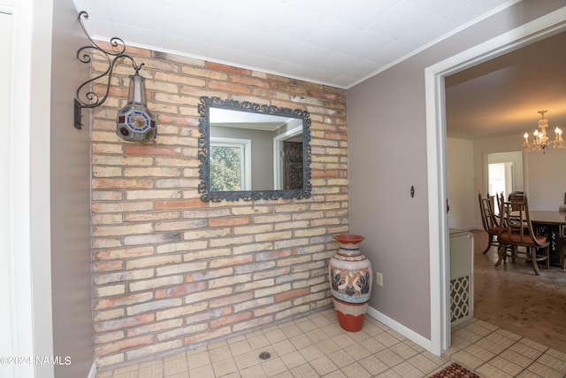 interior space with crown molding and a notable chandelier