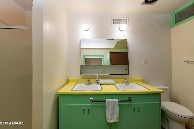 bathroom with toilet and vanity