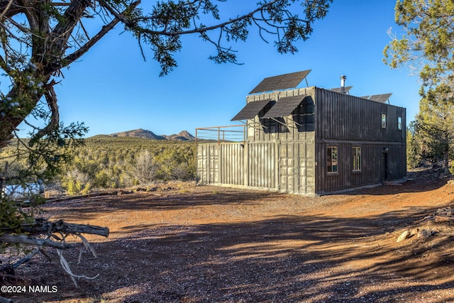 exterior space with a mountain view and an outbuilding