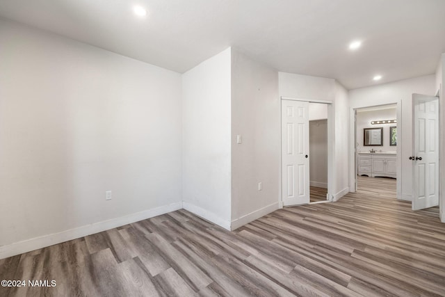 unfurnished room with light wood-type flooring