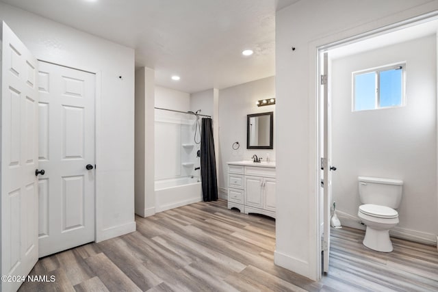 full bathroom with shower / bath combo, hardwood / wood-style flooring, toilet, and vanity