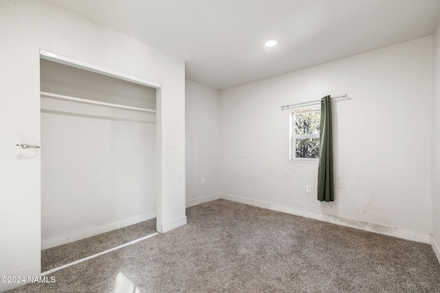 unfurnished bedroom with a closet and carpet flooring