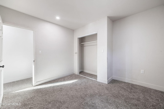 unfurnished bedroom with carpet and a closet