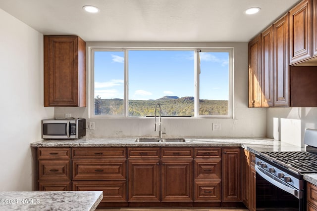 kitchen with sink, appliances with stainless steel finishes, plenty of natural light, and a mountain view