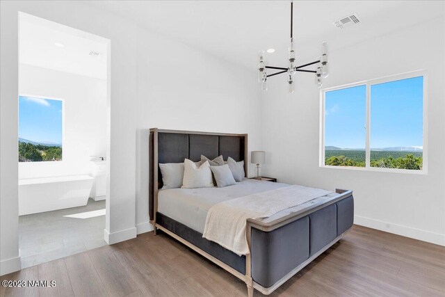 bedroom featuring a notable chandelier and wood-type flooring