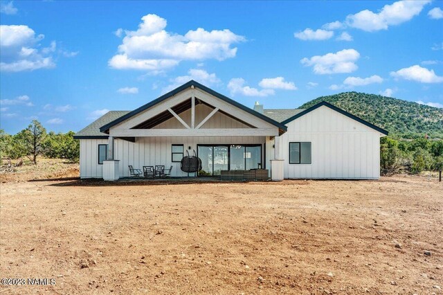 rear view of house featuring a mountain view