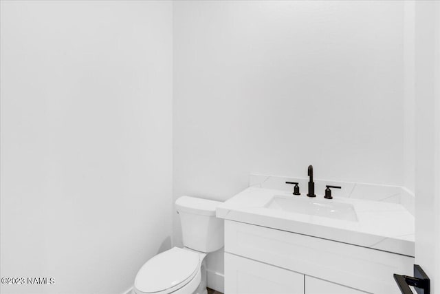 bathroom featuring toilet and vanity