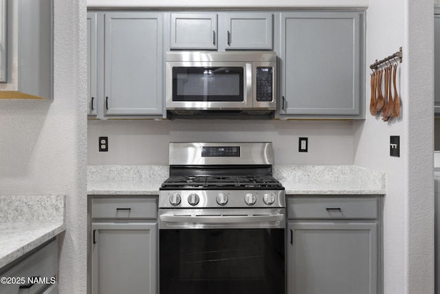 6437 N Conrad Ln, Flagstaff, AZ 86004 - kitchen with appliances with stainless steel finishes and gray cabinets