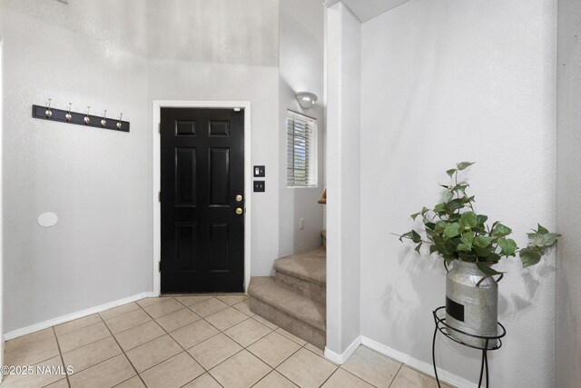 6437 N Conrad Ln, Flagstaff, AZ 86004 - entryway featuring light tile patterned floors, stairway, and baseboards