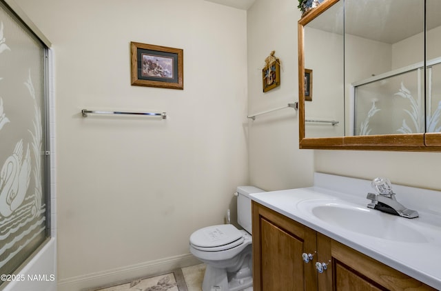 bathroom featuring baseboards, vanity, and toilet