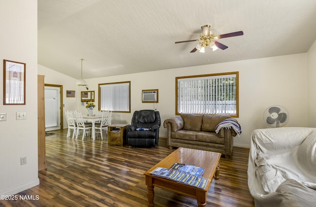 living room with a wall unit AC, lofted ceiling, ceiling fan, wood finished floors, and baseboards