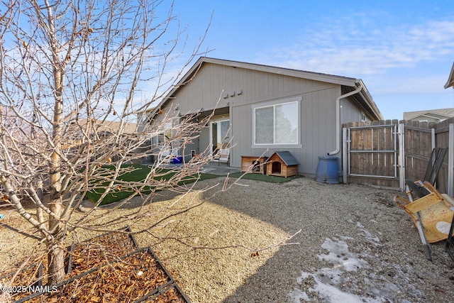 rear view of house with a patio and fence