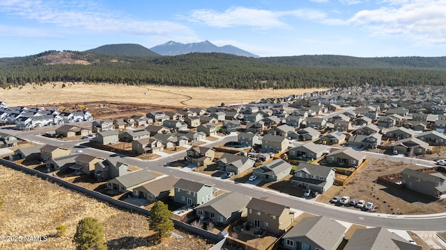 drone / aerial view featuring a residential view and a mountain view