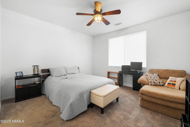 bedroom featuring light carpet, visible vents, and a ceiling fan