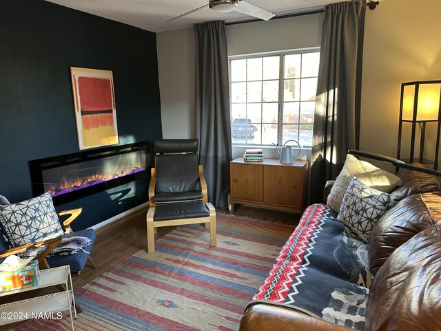 sitting room with hardwood / wood-style flooring and ceiling fan