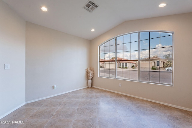 spare room featuring vaulted ceiling