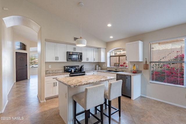 kitchen featuring sink, electric range oven, a center island, black dishwasher, and decorative light fixtures