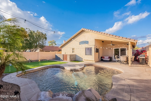 view of swimming pool with grilling area, ceiling fan, and a patio area