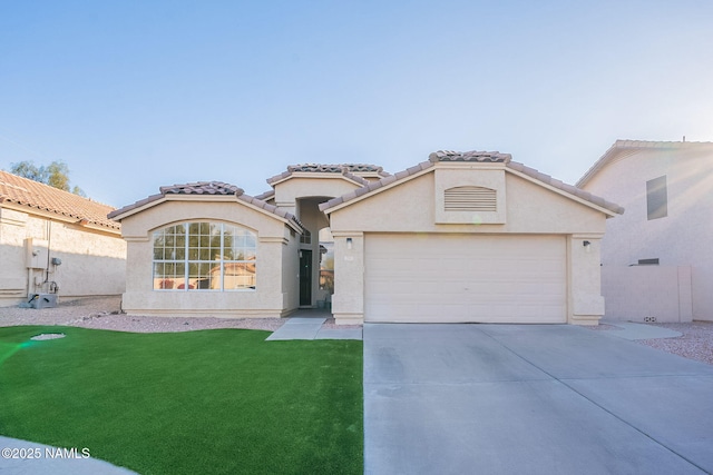 mediterranean / spanish-style home with a garage and a front lawn