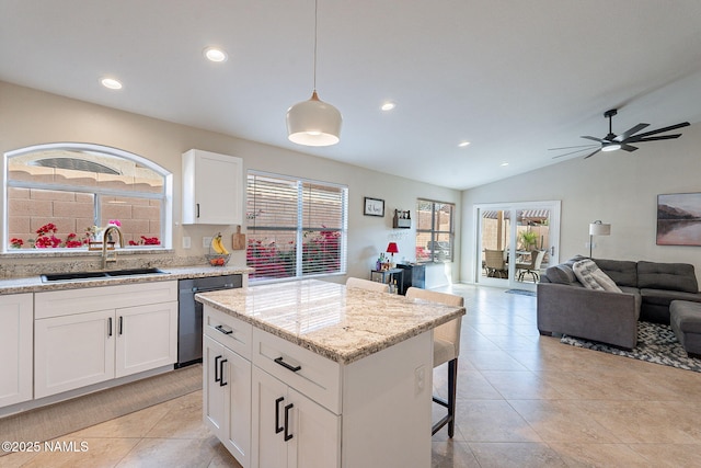 kitchen with decorative light fixtures, white cabinetry, dishwasher, sink, and a center island