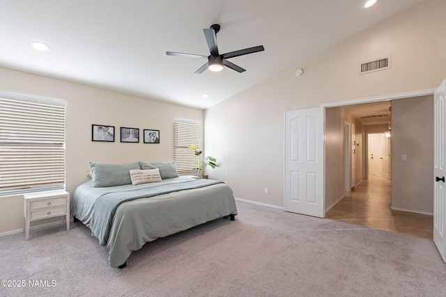 bedroom featuring light carpet, high vaulted ceiling, and ceiling fan