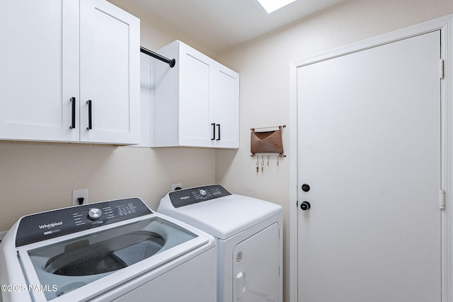 washroom with cabinets and washer and clothes dryer