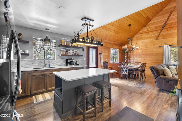 kitchen with a kitchen island, fridge, sink, and plenty of natural light