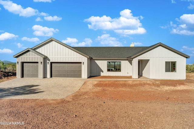 modern inspired farmhouse featuring a garage