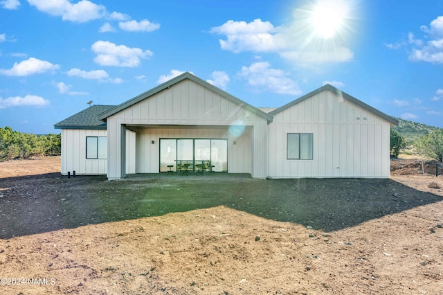 rear view of property with a lawn