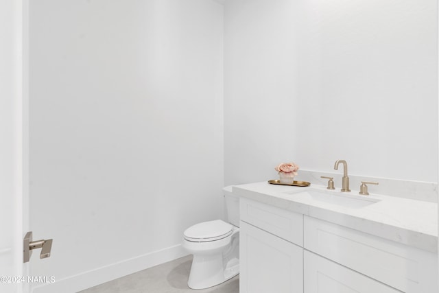 bathroom featuring vanity, toilet, and tile patterned floors