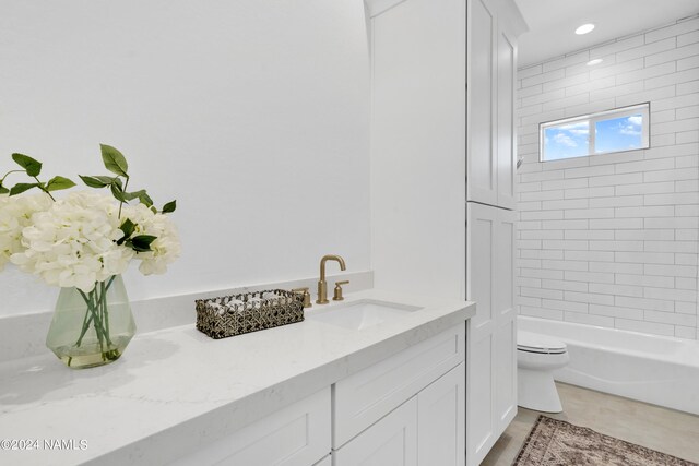 full bathroom with vanity, toilet, and tiled shower / bath combo