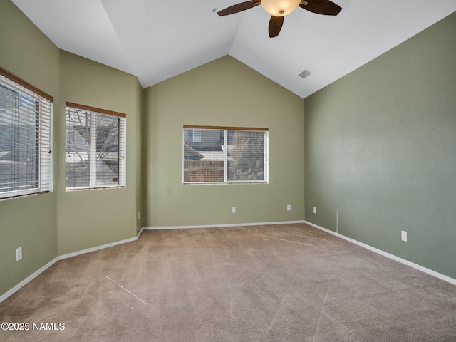 spare room with light carpet, baseboards, visible vents, lofted ceiling, and ceiling fan