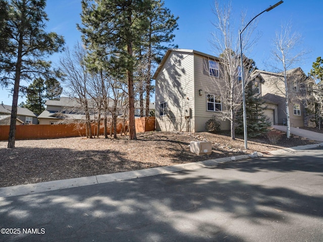 view of property exterior featuring fence