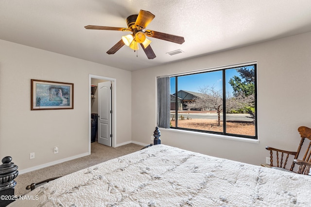 carpeted bedroom with baseboards, visible vents, ceiling fan, and a spacious closet