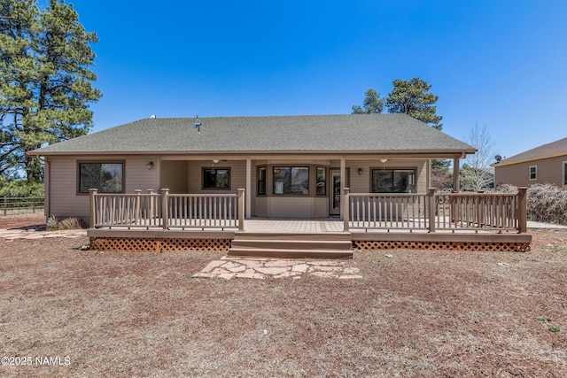 back of property featuring fence and roof with shingles