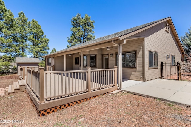 back of property featuring a patio, fence, ceiling fan, and a shingled roof