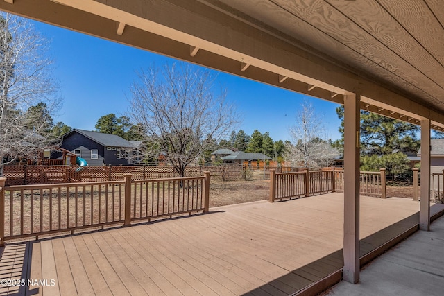 wooden deck featuring a residential view and a fenced backyard