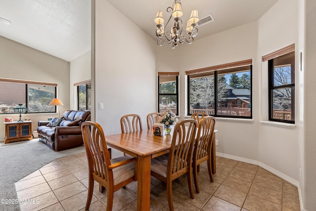 dining area with a chandelier, light tile patterned floors, baseboards, visible vents, and high vaulted ceiling