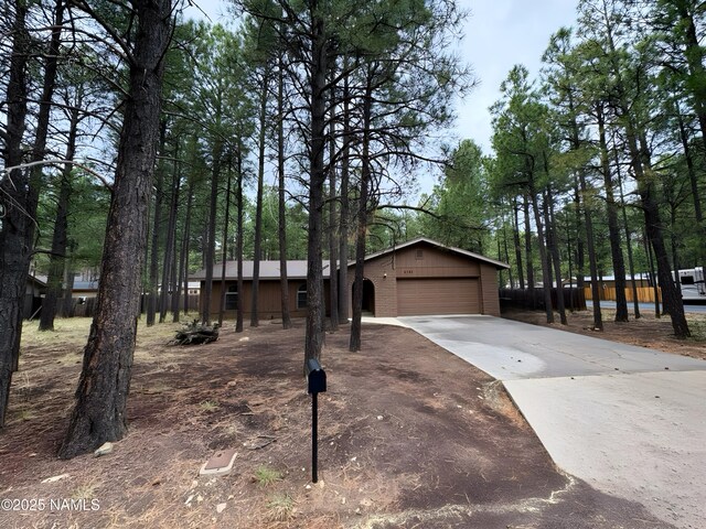 2787 N Pebble Beach Dr, Flagstaff, AZ 86004 - view of front facade featuring a garage, driveway, and an outbuilding