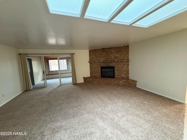 2787 N Pebble Beach Dr, Flagstaff, AZ 86004 - unfurnished living room featuring a fireplace, carpet flooring, baseboards, and a skylight