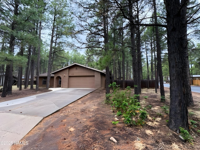 2787 N Pebble Beach Dr, Flagstaff, AZ 86004 - view of front facade with brick siding, concrete driveway, and a garage