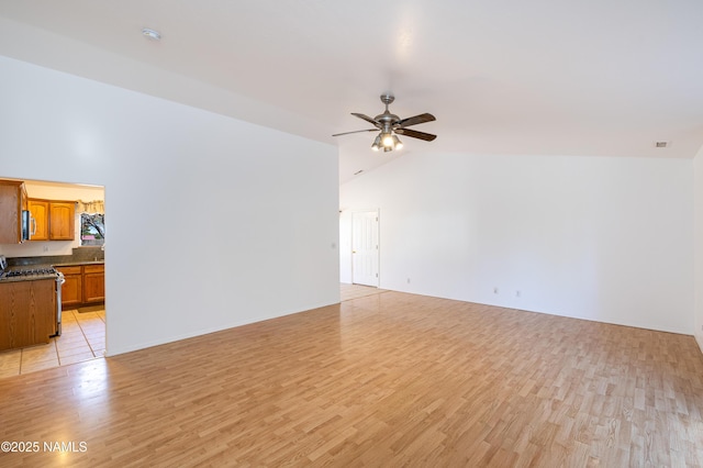 6120 E Treadway Trl, Flagstaff, AZ 86004 - unfurnished living room with lofted ceiling, light wood-type flooring, and a ceiling fan