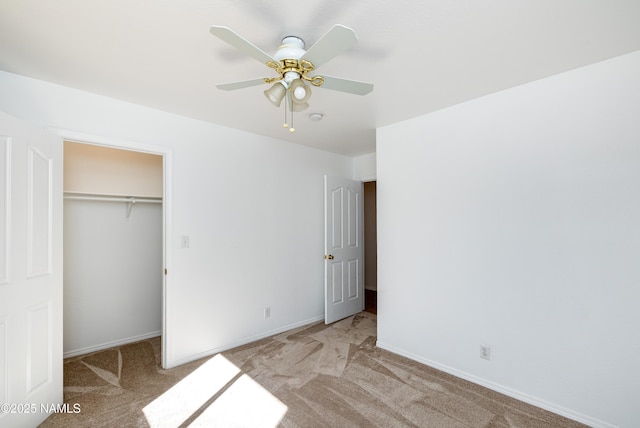 6120 E Treadway Trl, Flagstaff, AZ 86004 - unfurnished bedroom featuring light colored carpet, a closet, baseboards, a ceiling fan, and a spacious closet