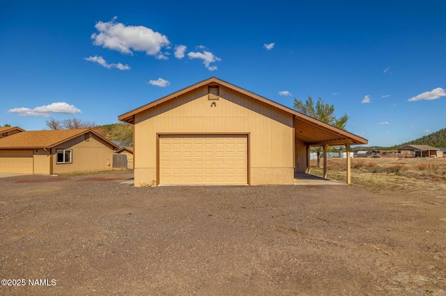 6120 E Treadway Trl, Flagstaff, AZ 86004 - view of front of property featuring a detached garage, an outbuilding, and dirt driveway